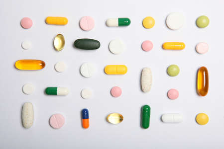 pills on a light background top view. Medicine, treatment, illness.の写真素材