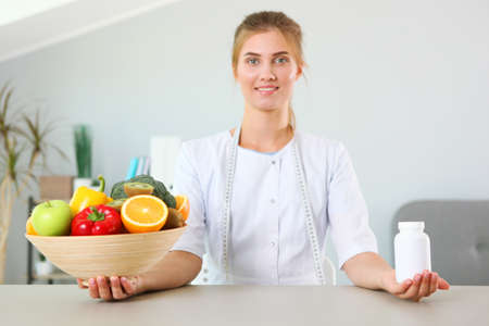 doctor nutritionist in her office demonstrates the concept of healthy eating.の写真素材