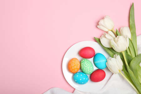 Easter eggs and flowers on the table top view.