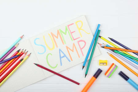 The inscription summer camp on a colored background top view.