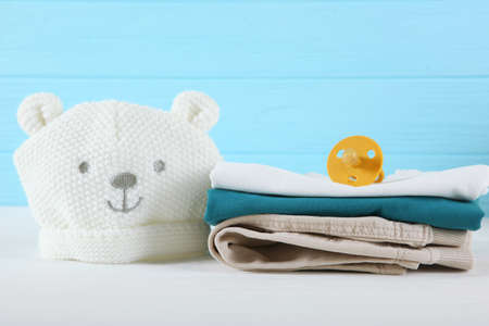 a stack of baby clothes on a light background.の写真素材