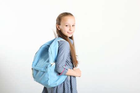Portrait of schoolgirl with a backpack and stationery.の写真素材