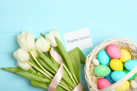 Easter eggs and flowers on the table top view.