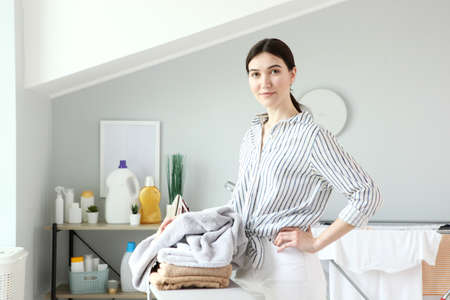 Young housewife in the laundry room.の写真素材