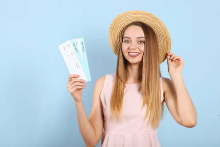 Beautiful young smiling girl holds tickets for travel. Rest, travel, tour.の写真素材