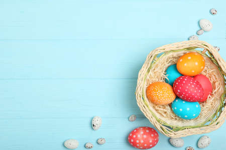 Easter eggs and flowers on the table top view.