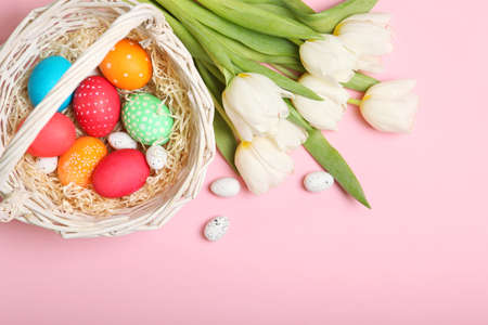 Easter eggs and flowers on the table top view.