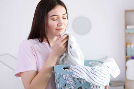 Young housewife in the laundry room.
