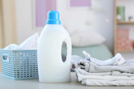 Baby clothes and detergents on the table. Baby clothes care concept.の写真素材