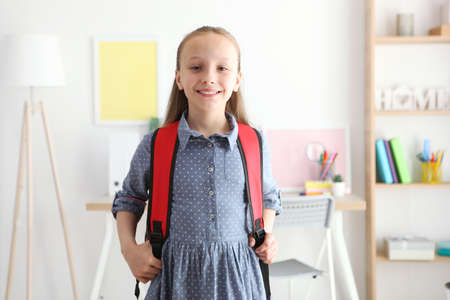 Portrait of schoolgirl with a backpack and stationery.の写真素材