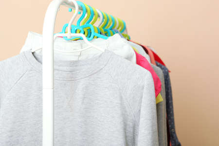 Children clothes on a hanger on a colored background.