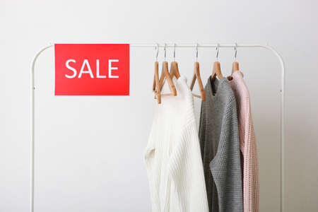Clothes on the rail and a sale sign. Final sale, discountsの写真素材