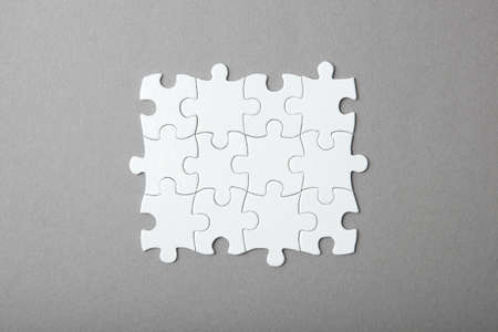 White puzzle on a colored background top view.の写真素材