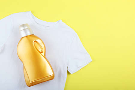 Laundry detergent bottles and clothes on the table. Household chemicalsの写真素材