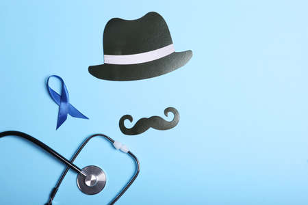 Blue ribbon on a colored background top view. Mens cancer, mens health.
