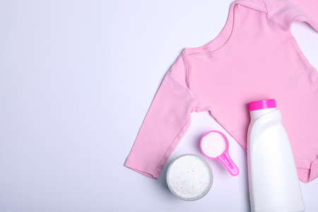 Baby clothes and detergents on a colored background top view.の写真素材