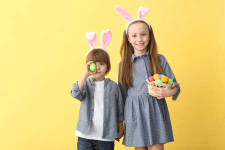 Cute little boy and girl in rabbit ears and with an Easter basket