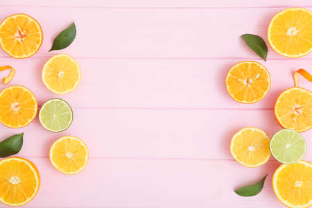Different citrus and juicy slices on a colored background. Place to insert text.