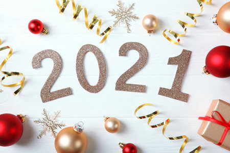 Composition with numbers 2021 and Christmas decor on a colored backgroundの写真素材