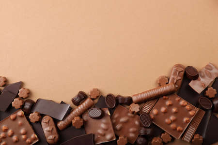 Chocolate of different types on a colored background with a place for textの写真素材