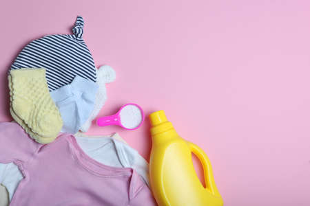 Baby clothes and detergents on a colored background top view.の写真素材