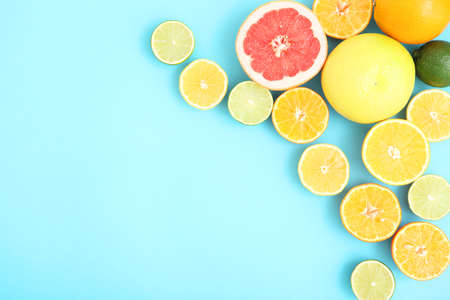 Different citrus and juicy slices on a colored background. Place to insert text.の写真素材