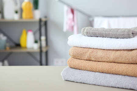 clean towels and laundry detergents in the laundry roomの写真素材