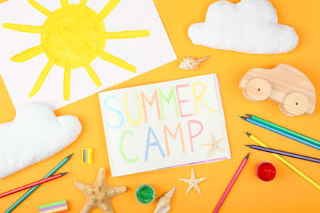 The inscription summer camp on a colored background top view.