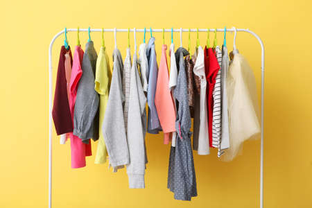 Children clothes on a hanger on a colored background.の写真素材
