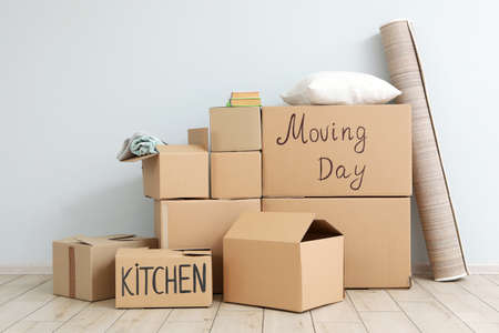 Cardboard boxes and household stuff in empty room.の写真素材