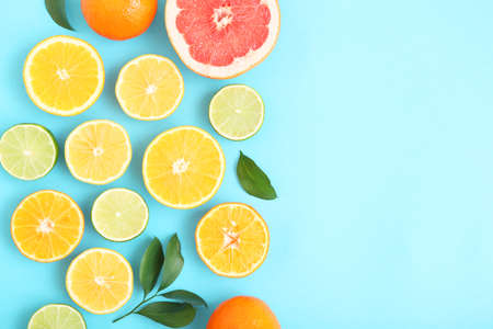 Different citrus and juicy slices on a colored background. Place to insert text.の写真素材