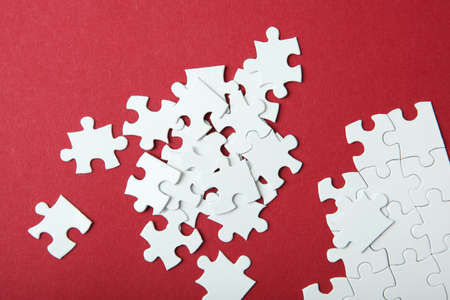 White puzzle on a colored background top view.