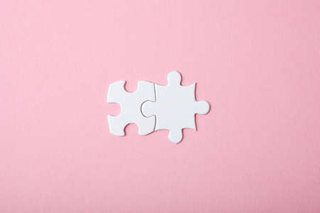 White puzzle on a colored background top view.の写真素材