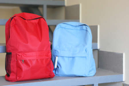 School backpack and stationery in a bright room.