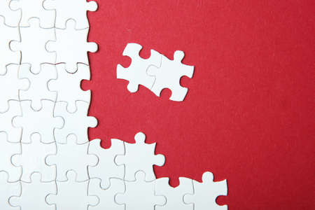 White puzzle on a colored background top view.