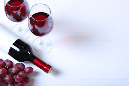 red wine and grapes on the table top view.の写真素材