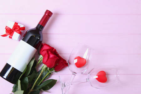 red wine and roses on the table. Valentines day background.の写真素材