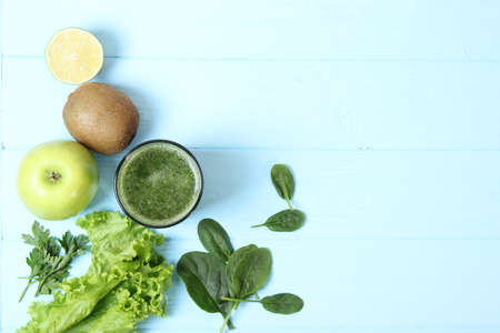 Green smoothie and fresh vegetables on the table for the detox organism