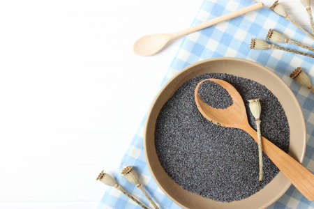 poppy seeds in a bowl on a tableの写真素材