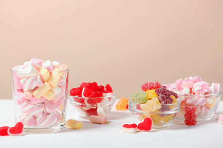 various candy and sweets on the table on a colored background.の写真素材