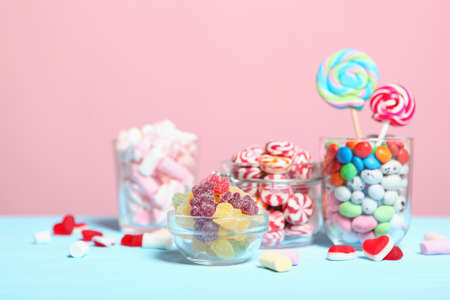 various candy and sweets on the table on a colored background.の写真素材