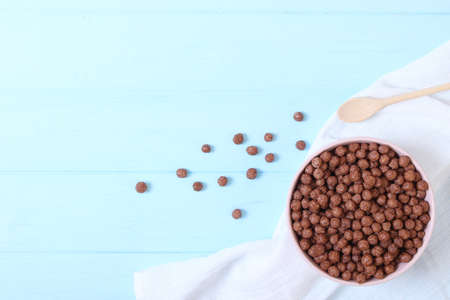 dry breakfast in a plate on a colored background top view. cereal