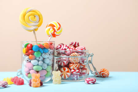 various candy and sweets on the table on a colored background.の写真素材