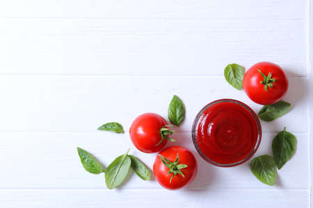 Ketchup on the table. Tomato sauce, fresh tomatoes.の写真素材