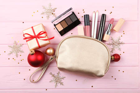 Beautiful composition with Christmas decor and makeup cosmetics top view.の写真素材