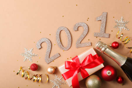 Composition with numbers 2021 and Christmas decor on a colored background