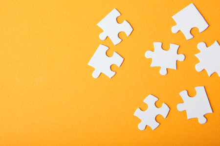 White puzzle on a colored background top view.の写真素材