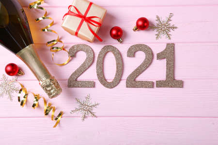 Composition with numbers 2021 and Christmas decor on a colored backgroundの写真素材