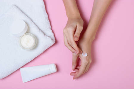 girl smears her hands cosmetic cream. skin careの写真素材