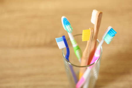 Natural bamboo and plastic toothbrushes on the table.の写真素材